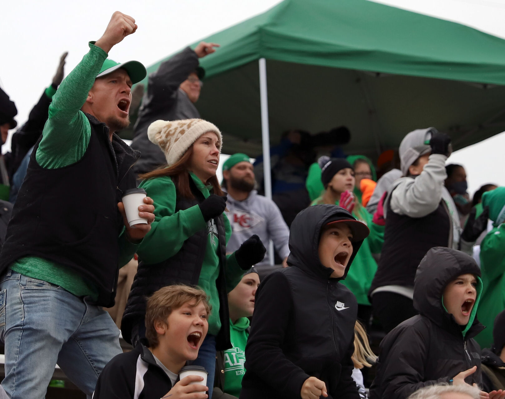Ryan Rademan, left, raises his fist and cheers for the Falcons